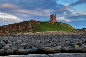 Dunstanburgh boulders await the incoming tide